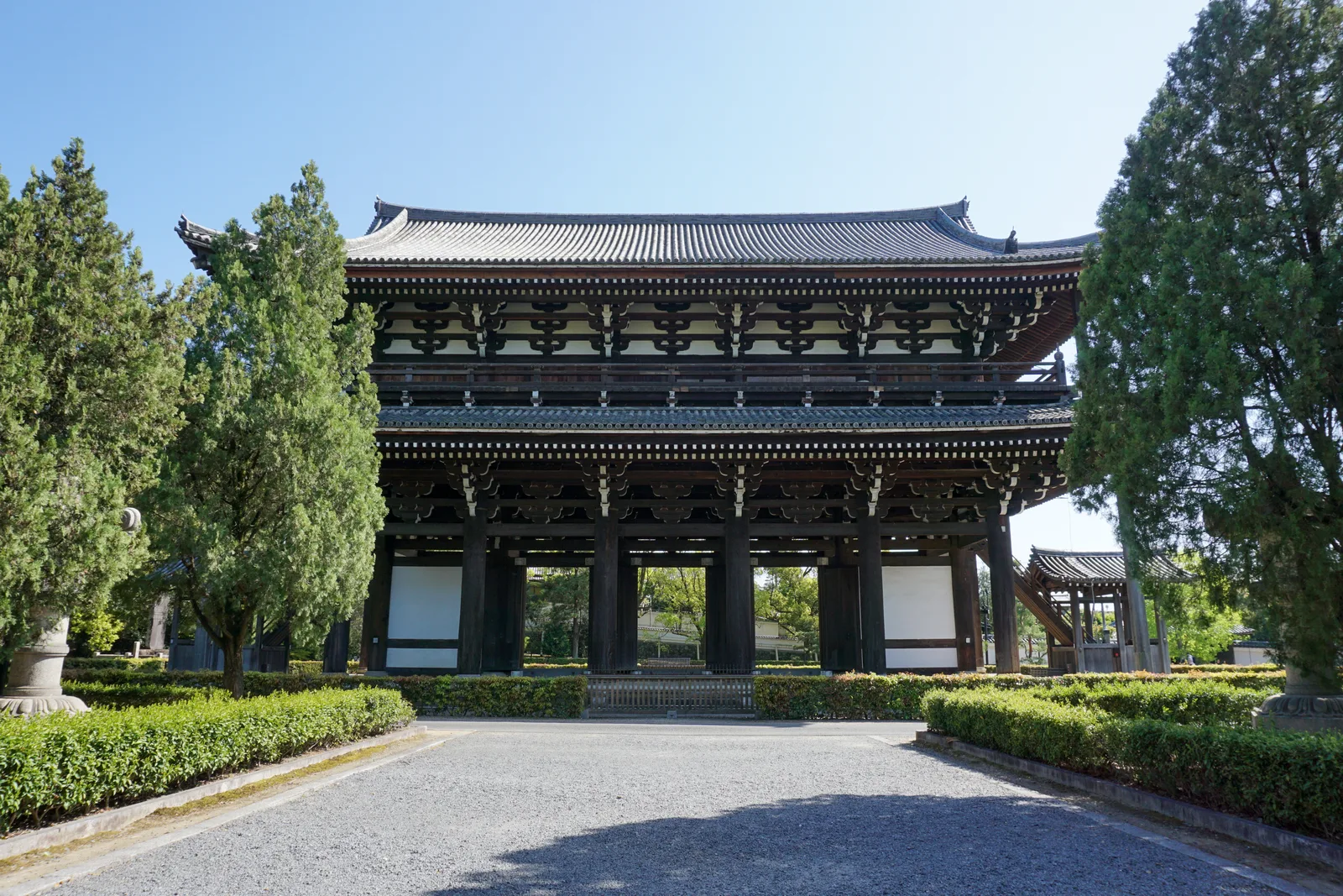 Timber Sanmon gate at the end of a tree-lined approach at Tofuku-ji Temple