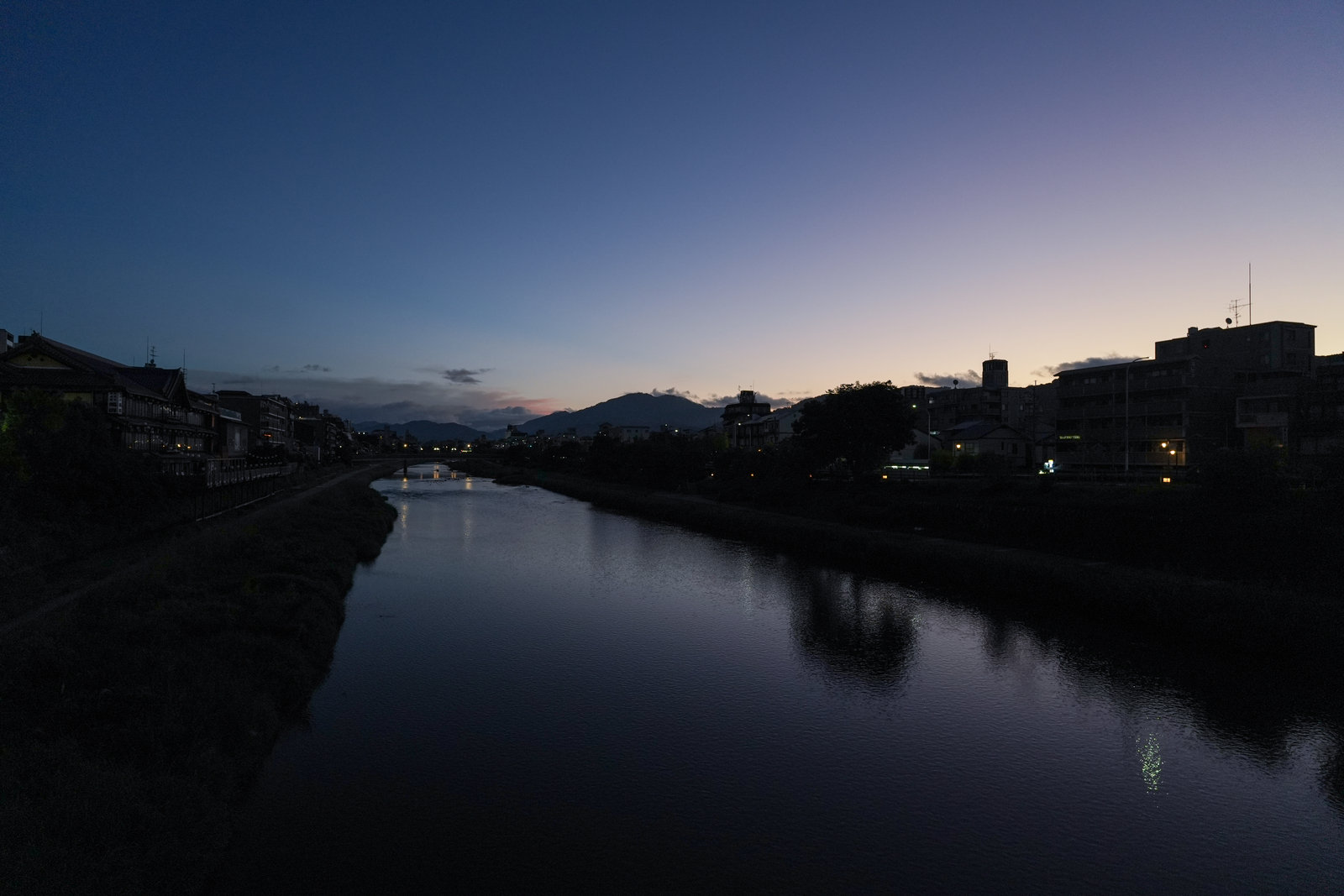 The Kamo River and Kyoto's distant mountains at dusk